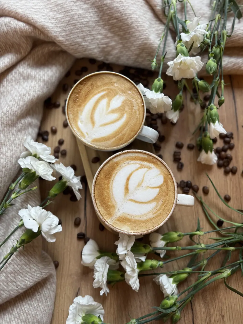 Two cappuccinos with latte art seen from above