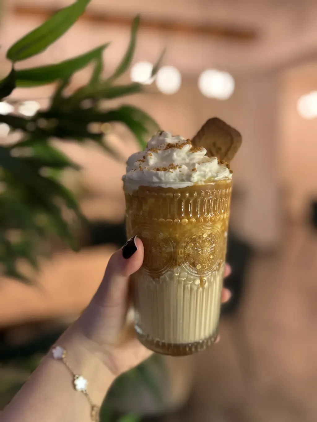 Iced coffee with whipped cream in a tall glass