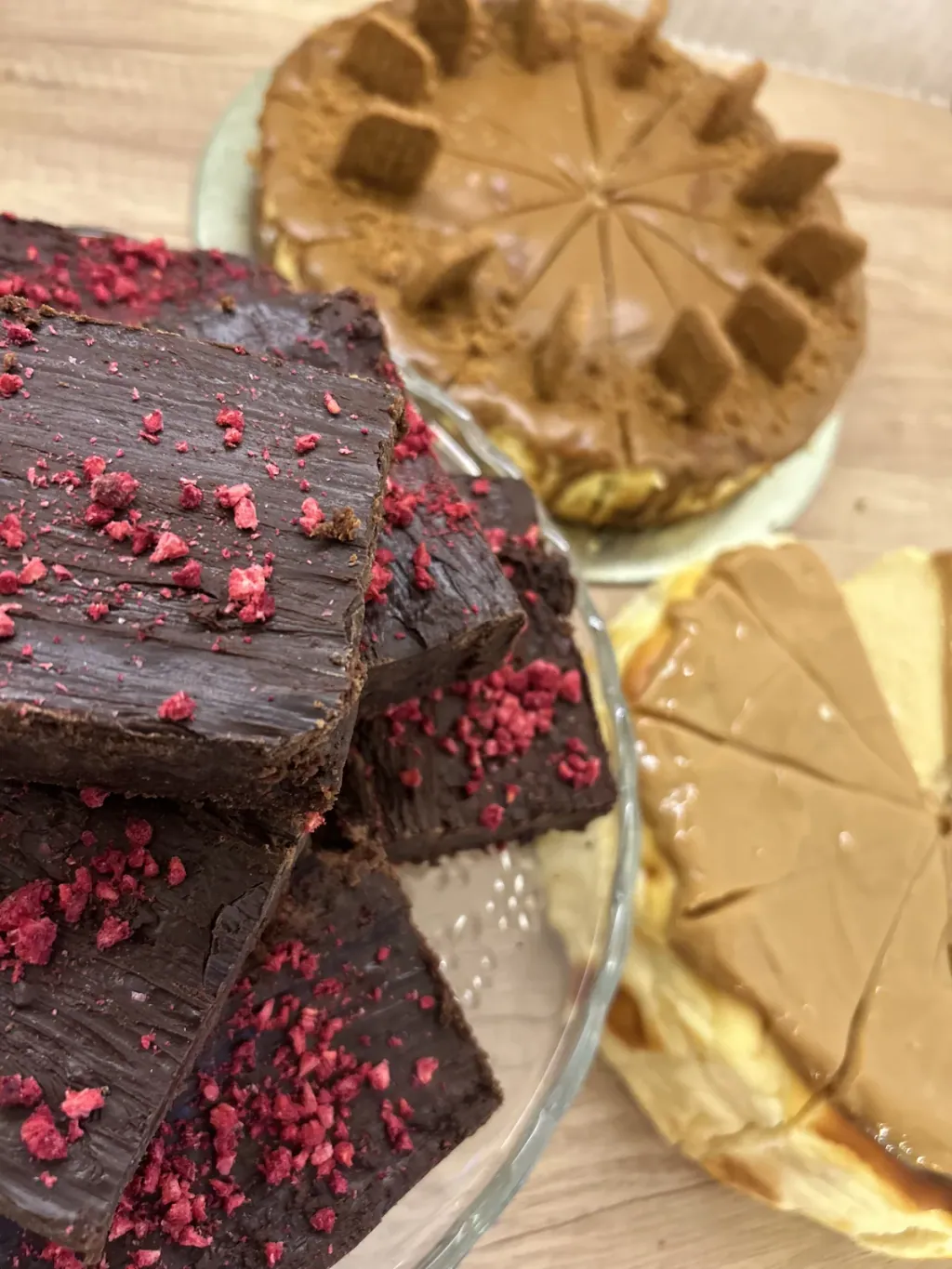 Brownie topped with freeze-dried raspberry on a cake stand