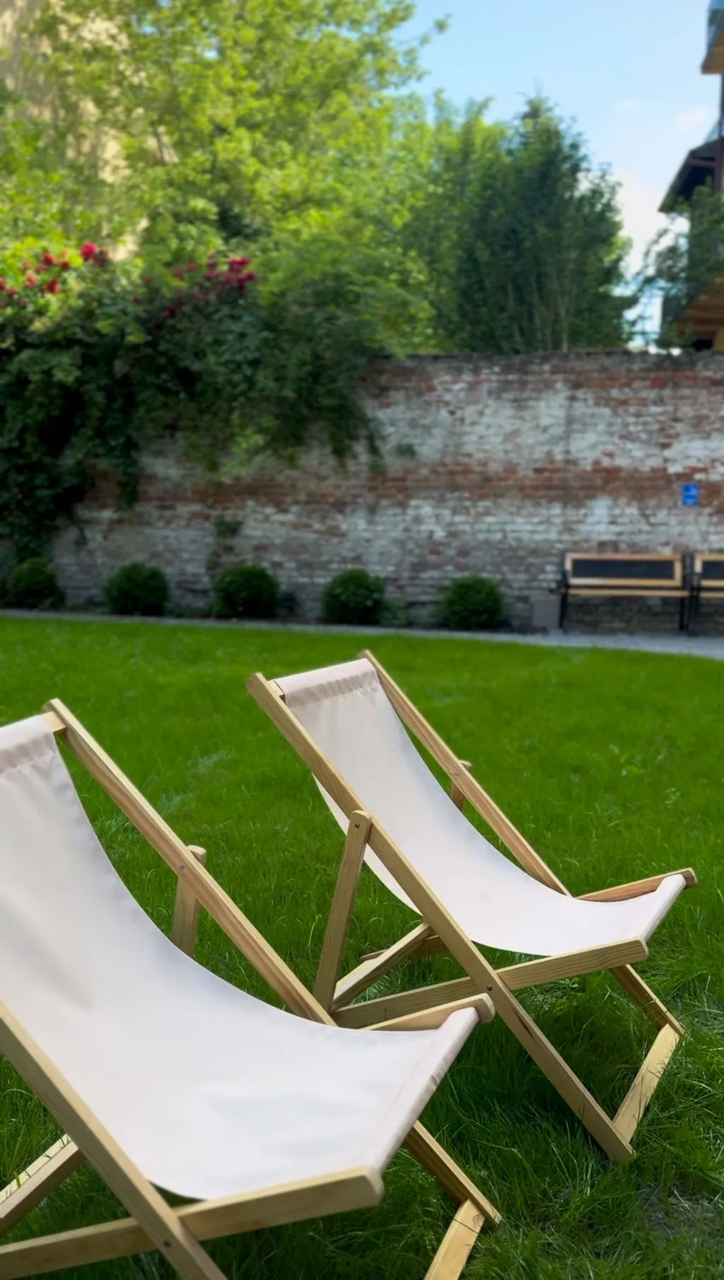 Two wooden deck chairs on the lawn of the Siesta Cafe garden