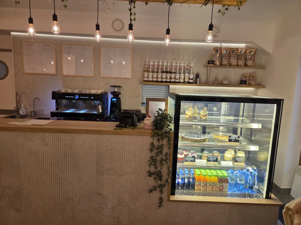 Coffee bar with espresso machine and cake display